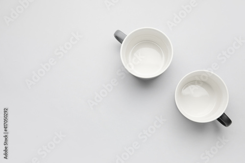 Empty cups on light background