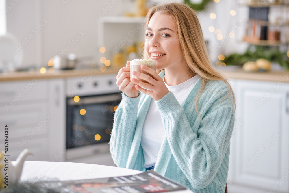 Beautiful young woman drinking hot chocolate at home on Christmas eve Beautiful young woman drinking hot chocolate at home on Christmas eve