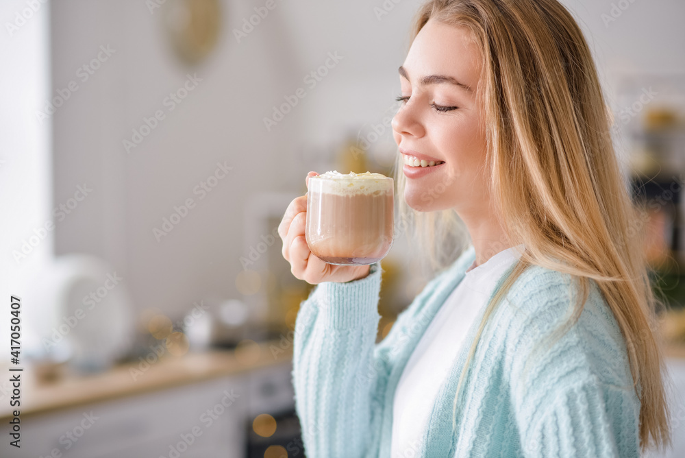 Beautiful young woman drinking hot chocolate at home Beautiful young woman drinking hot chocolate at home