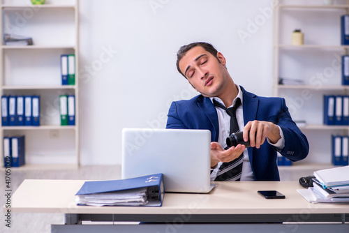 Sick male employee suffering at workplace