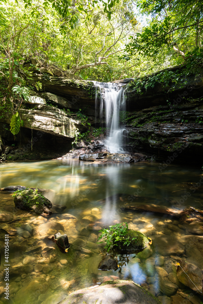 Fototapeta premium Kuura waterfall with its serene atmosphere illuminated by a soft sunligh. Iriomote Island.