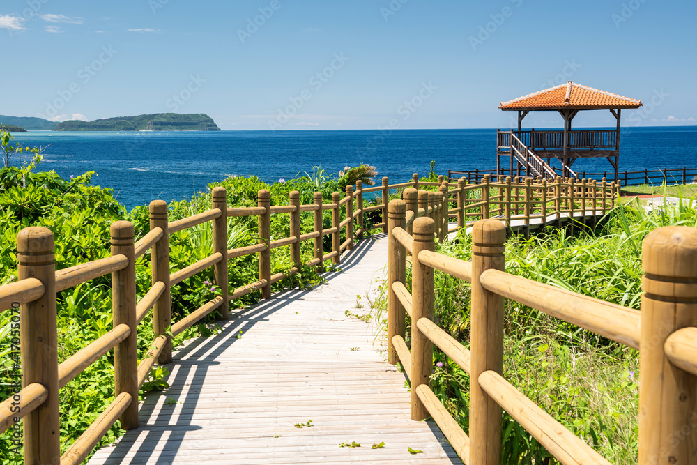 .Wooden path that leads to a point view lookout  to contemplate the beautiful seascape with its blue sea. Iriomote Island.