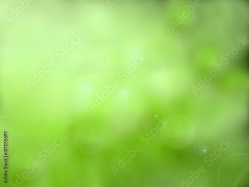 Abstract green bokeh background with bright sunny springtime. Fresh spring and summer green concept, blurry and defocus style.