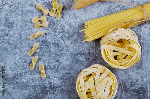 A bunch of various raw pasta on blue backgrounds
