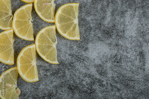 Slices of sour lemon on a gray background photo