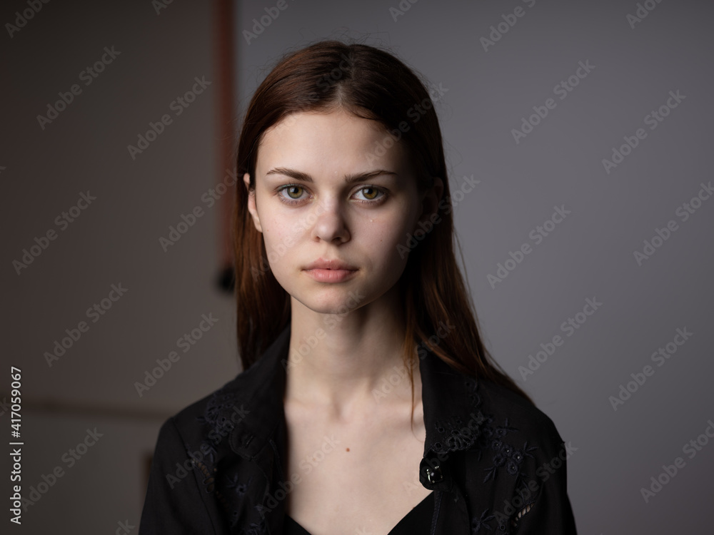 Portrait of a red-haired woman on a gray background beautiful face model cropped view Portrait of a red-haired woman on a gray background beautiful face model cropped view