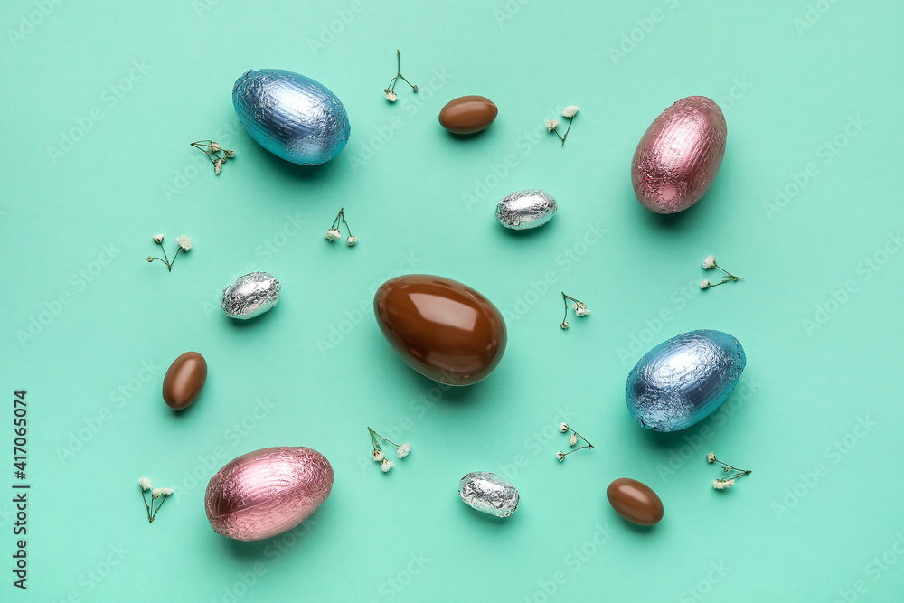 Composition with chocolate Easter eggs on color background Composition with chocolate Easter eggs on color background