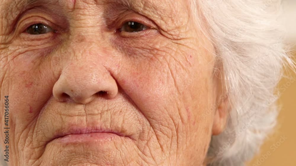 old age, tenderness-sweet toothless smile of elderly woman looking at the camera old age, tenderness-sweet toothless smile of elderly woman looking at the camera