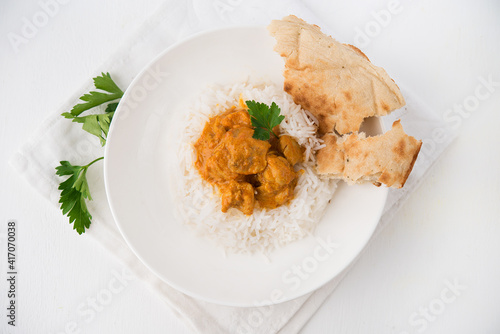 Chicken with rice in curry sauce-a traditional Indian dish on a white background