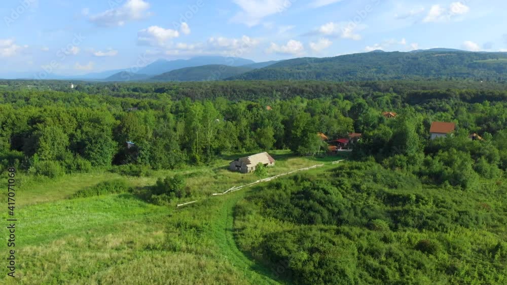 Drone. Aerial view. Summer. Sunny day. Abandoned old wooden farmhouse on a green meadow. Camera moves forward Drone. Aerial view. Summer. Sunny day. Abandoned old wooden farmhouse on a green meadow. Camera moves forward