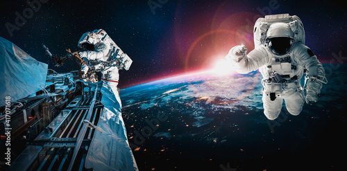 Fototapeta Naklejka Na Ścianę i Meble -  Astronaut spaceman do spacewalk while working for space station in outer space . Astronaut wear full spacesuit for space operation . Elements of this image furnished by NASA space astronaut photos.