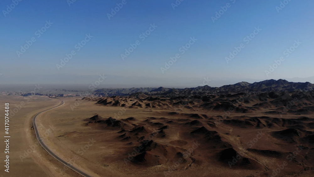 arid desert mountains.
Aerial view from drones to dry mountains. Vast open desert landscape. Clay mountains
Earth destroyed by erosion and global warming