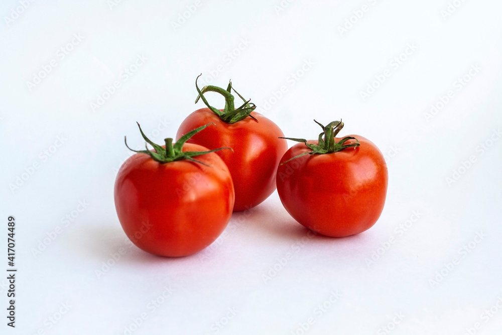 Three red tomatoes isolated on a white background Three red tomatoes isolated on a white background