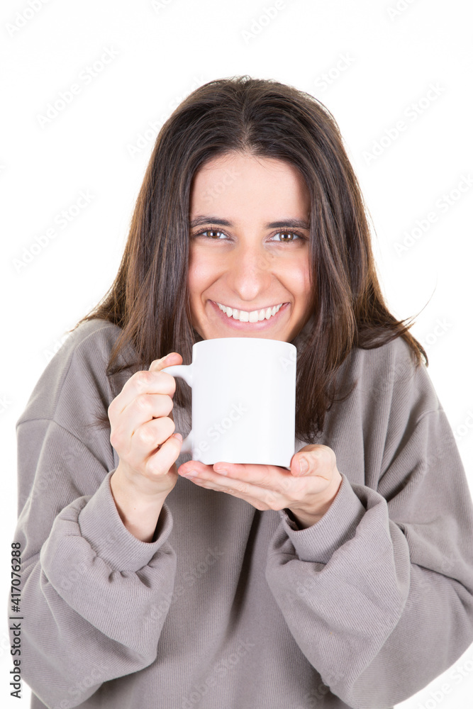 Attractive girl is holding a hot drink white mug in white background Attractive girl is holding a hot drink white mug in white background