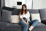 woman sitting on the couch apartment leisure comfort