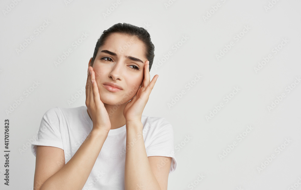 woman holding face headache and migraine health problems woman holding face headache and migraine health problems