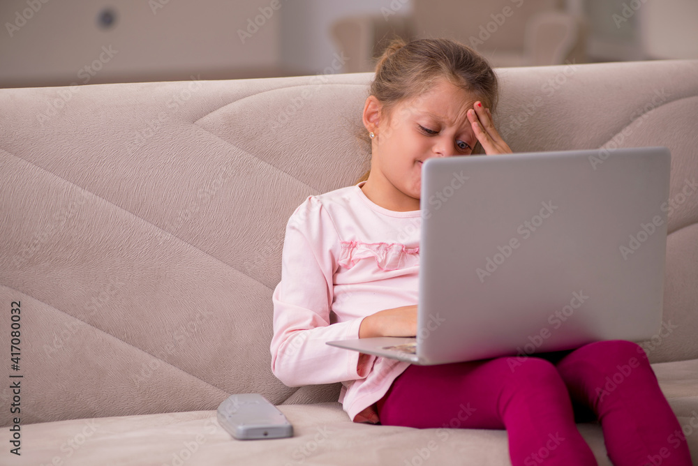 Small girl in tele-education concept at home Small girl in tele-education concept at home