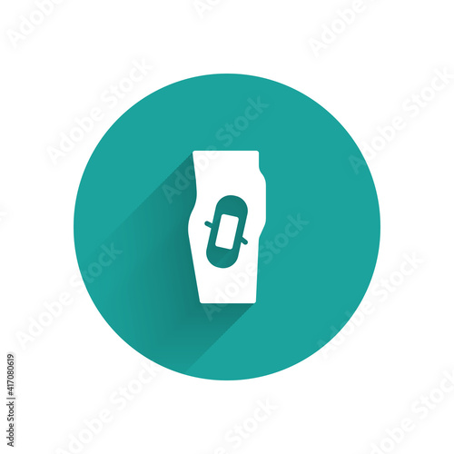 White Plaster on leg icon isolated with long shadow. Green circle button. Vector.