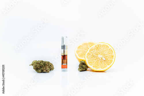 Cannabis, vape cartridge and lemons. Limonene terpene concept. photo