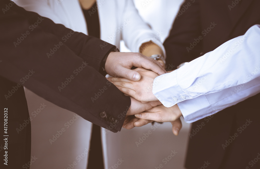 Group of unknown businesspeople are joining hands in a modern office. Unknown businessmen are making circle with their hands. Concept of trust and support in a business Group of unknown businesspeople are joining hands in a modern office. Unknown businessmen are making circle with their hands. Concept of trust and support in a business