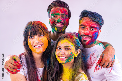 happy teenager friends with colour face and hair feeling good emotions together in white studio