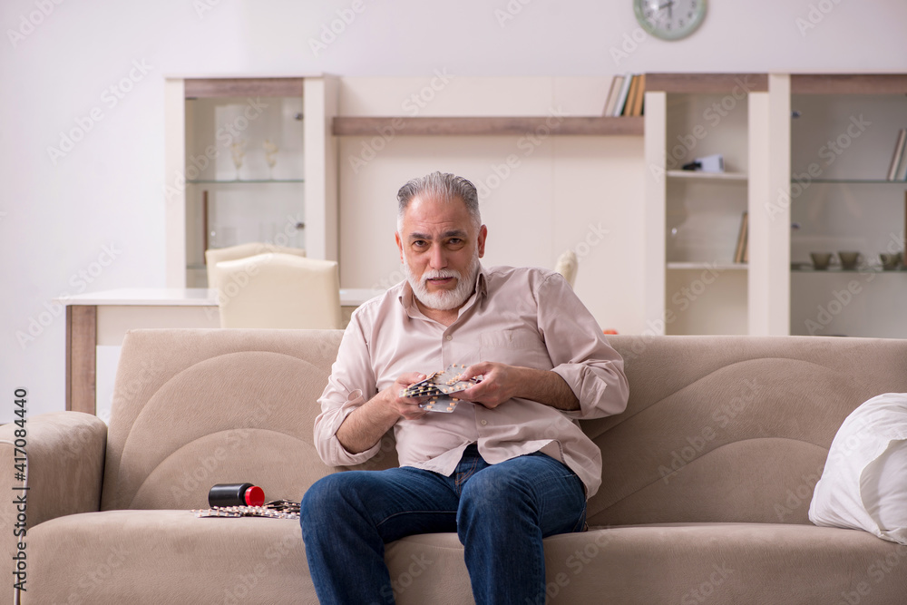 Old sick man suffering at home Old sick man suffering at home