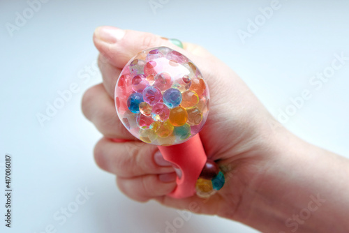 Wallpaper Mural Rubber toy antistress in a woman's hand on a white background. Torontodigital.ca