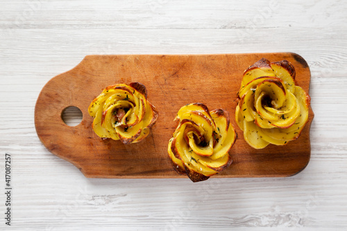 Homemade Potato Roses on a rustic wooden board, top view. Flat lay, overhead, from above.