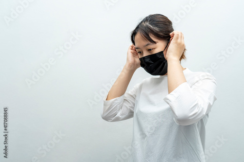 Asian Woman wearing an anti virus protection mask or  face mask during coronavirus and flu outbreak and prevent others from corona COVID-19 and SARS cov 2 infection.