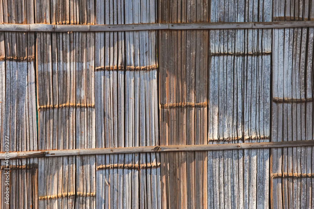 Beautiful patterned bamboo wall, hill tribe house, sunlight Beautiful patterned bamboo wall, hill tribe house, sunlight