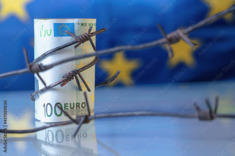 © zwiebackesser - Close up EU money wrapped in barbed wire against flag of European Union as symbol of economic warfare, sanctions and embargo busting. Copy space for design or text © zwiebackesser - Close up EU money wrapped in barbed wire against flag of European Union as symbol of economic warfare, sanctions and embargo busting. Copy space for design or text