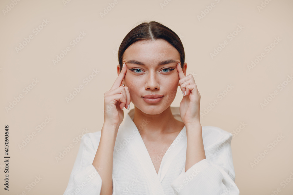 Young beautiful woman doing face building facial gymnastics self massage and rejuvenating exercises Young beautiful woman doing face building facial gymnastics self massage and rejuvenating exercises