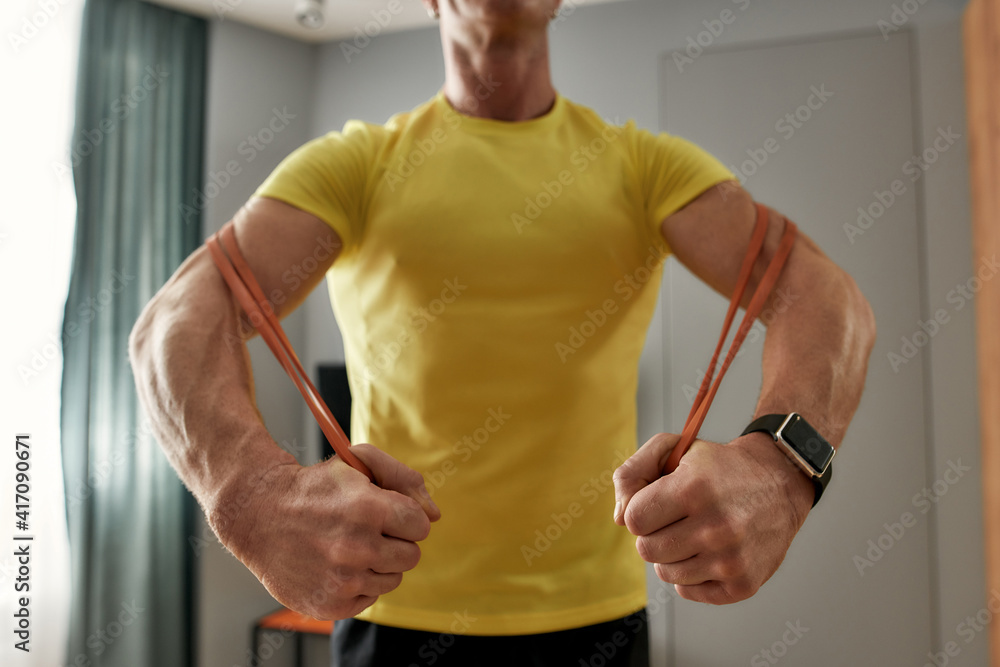 Athlete exercising at home with elastic band Athlete exercising at home with elastic band