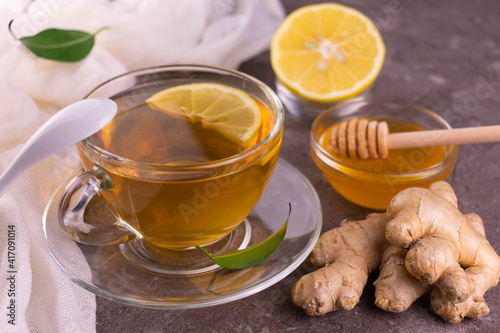 A cup of ginger tea with honey and lemon.
Close-up.