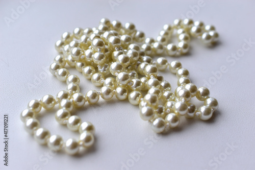 White pearl necklace beads on white background