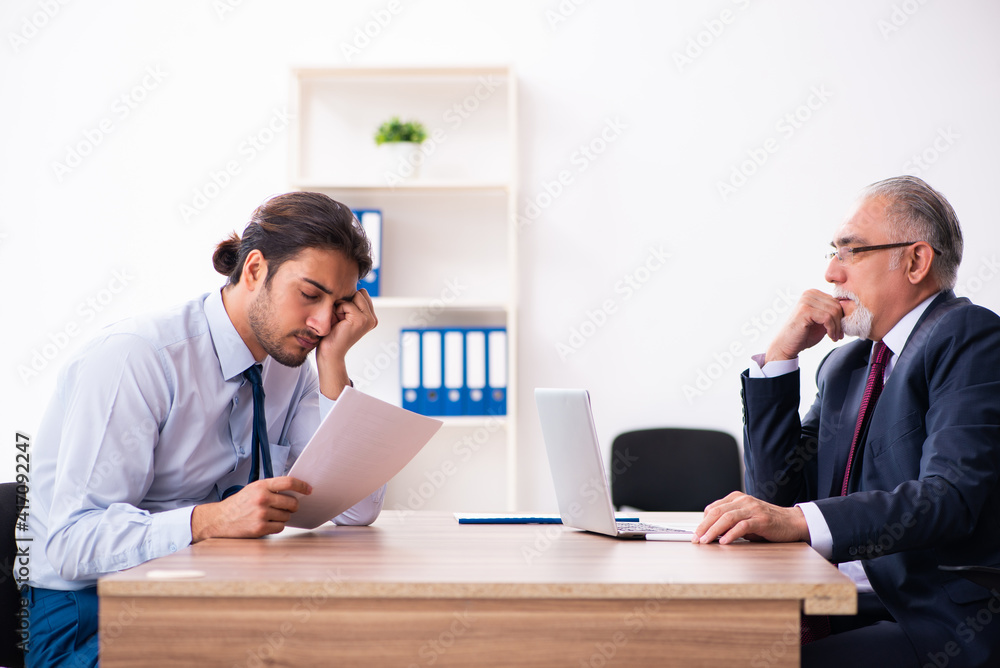 Young male candidate employee meeting with old recruiter Young male candidate employee meeting with old recruiter