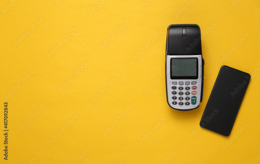 Payment terminal with smartphone on pink blue background. Contactless payment. Copy space. Top view