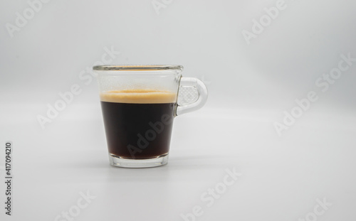 Close up of a glass of espresso isolated on white