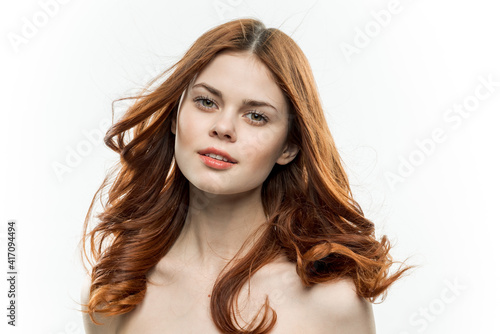 portrait of a woman with bare shoulders red hair cosmetics close-up