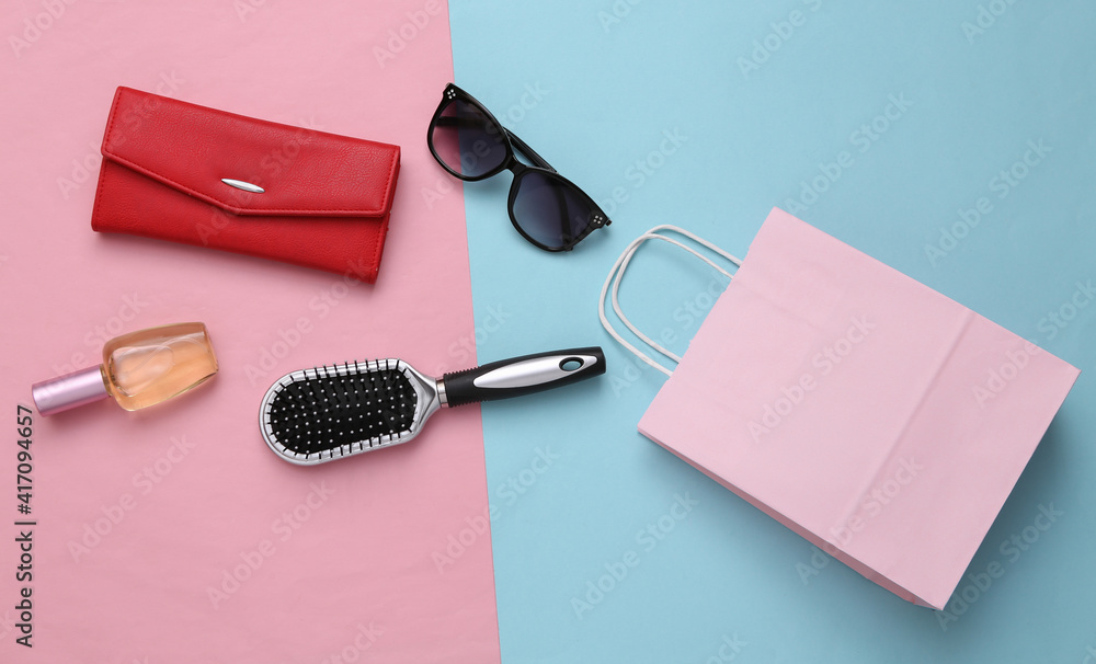 Shopping bag with accessories on a pink background. Shopping concept. Top view Shopping bag with accessories on a pink background. Shopping concept. Top view