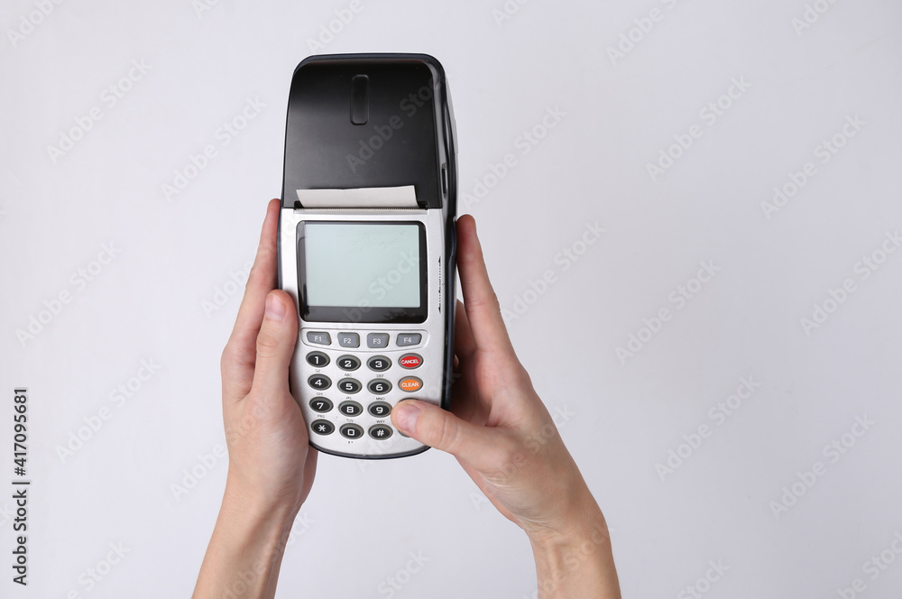 Hand holds payment terminal on white background. Payment for purchases Hand holds payment terminal on white background. Payment for purchases