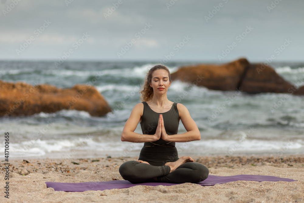 Young yogi woman meditates on the beach. Harmony, balance Young yogi woman meditates on the beach. Harmony, balance