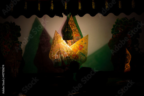 wayang kulit or shadow puppets from Java, Indonesia
puppet show by dalang or puppeteer . Wayang made from leather photo