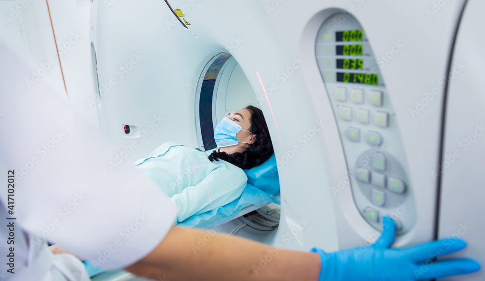 Naklejka premium Radiologist with a female patient in the room of computed tomography