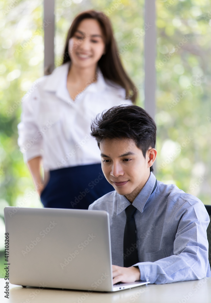 Beautiful black long hair Asian businesswoman and gook looking cute Asian businessman working together in office with intimate gesture and teamwork pose Beautiful black long hair Asian businesswoman and gook looking cute Asian businessman working together in office with intimate gesture and teamwork pose