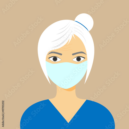 An attractive older woman with gray hair pulled back in a bun and a mask on her face. Coronavirus.