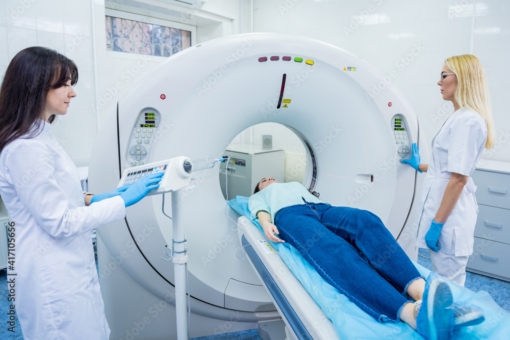 Radiologist with a female patient in the room of computed tomography Radiologist with a female patient in the room of computed tomography