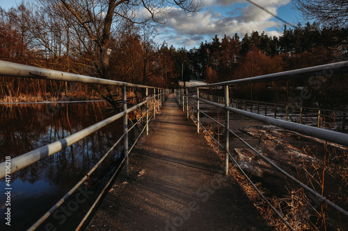 bridge in the forest in winter, golden hour  © Jakub Tabisz
