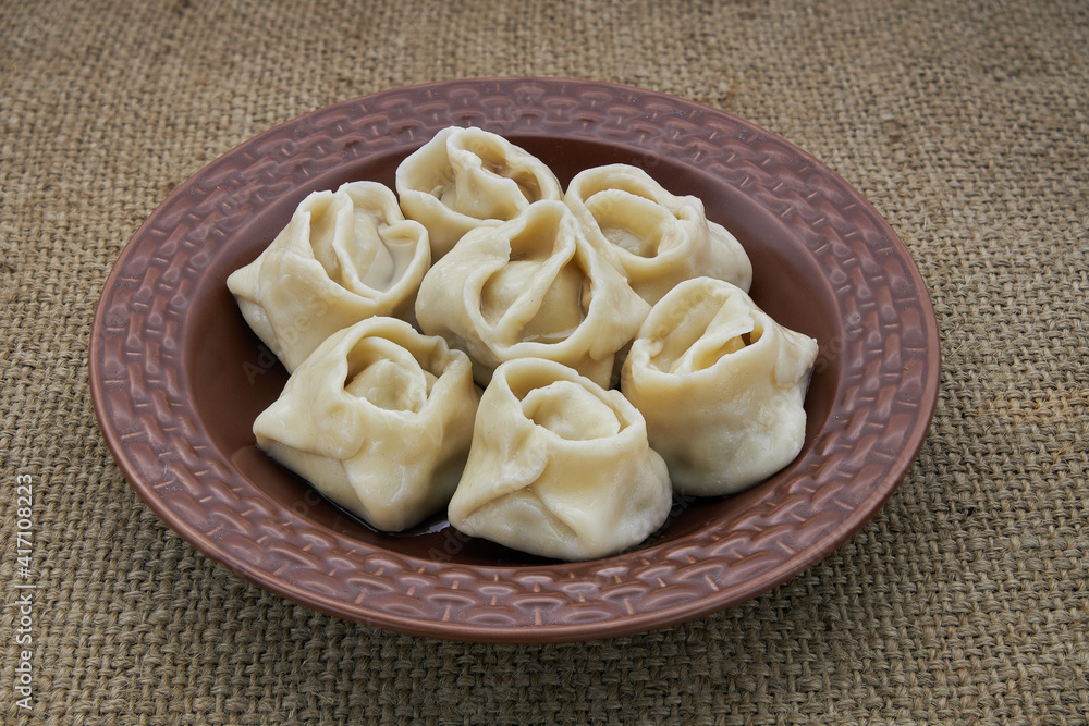 Dumplings in a brown plate on burlap Dumplings in a brown plate on burlap