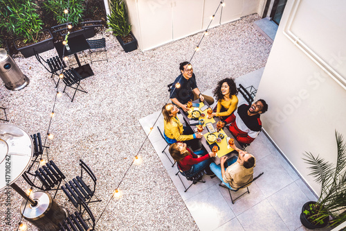 Canvas Print High angle top view of happy friends drinking cocktails and having fun at restau